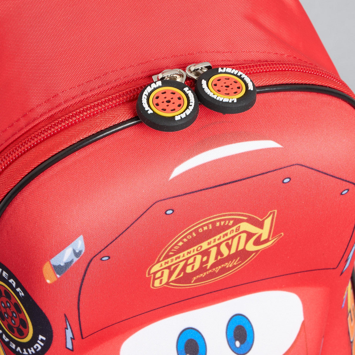 Car print backpack with adjustable shoulder straps and zip closure