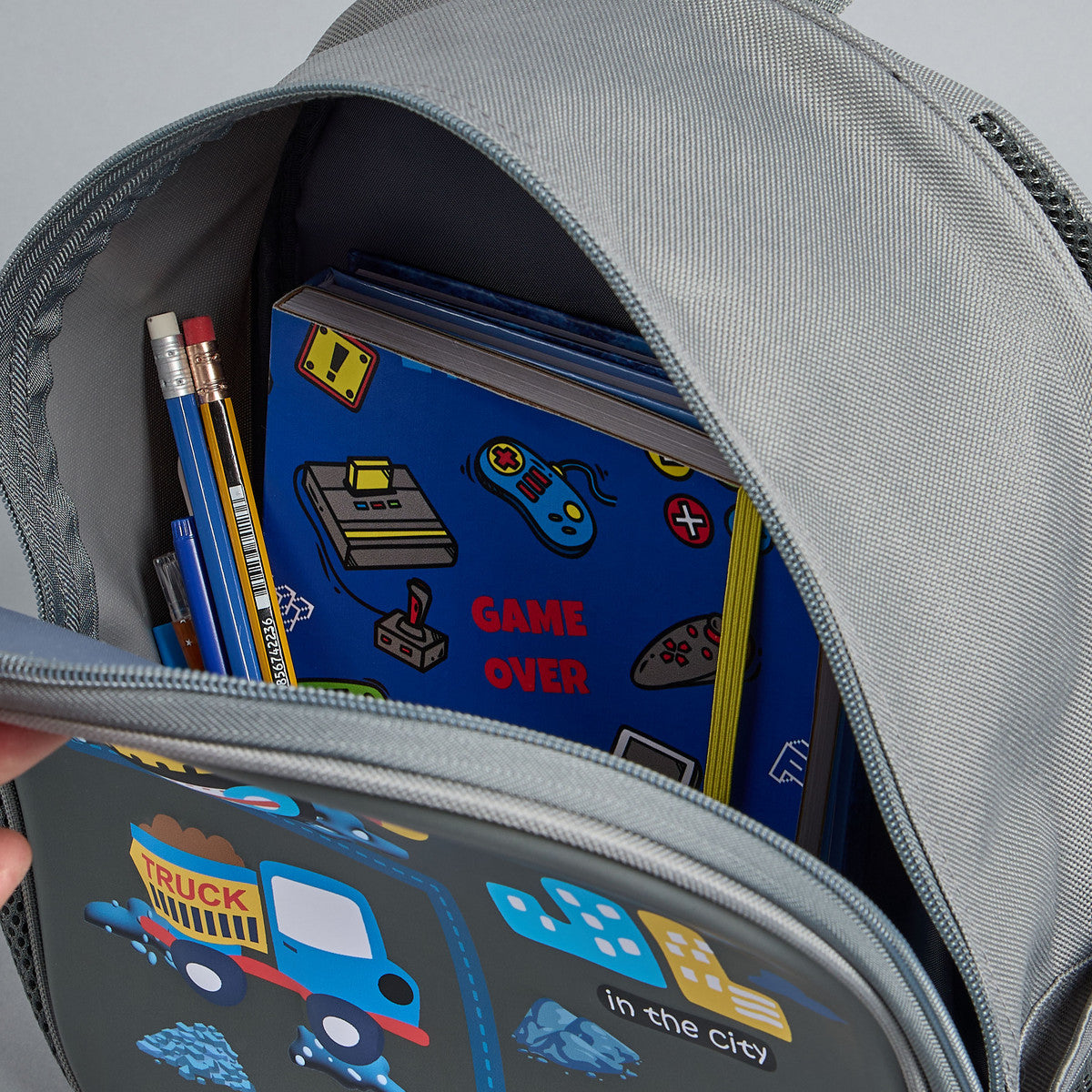 Construction vehicle print backpack with adjustable straps and zip closure